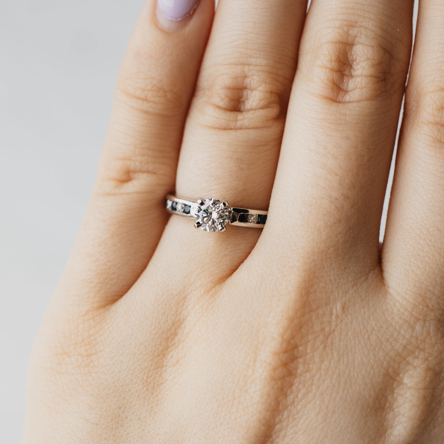 Triple X Round Brilliant Diamond and Sapphire Accented Solitaire Ring